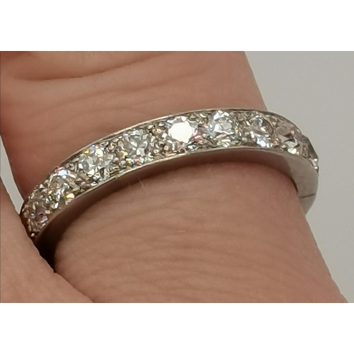 401 - A platinum and diamond eternity ring, the band set with 21 stones, unmarked, in a Garrard & Co Ltd b... 