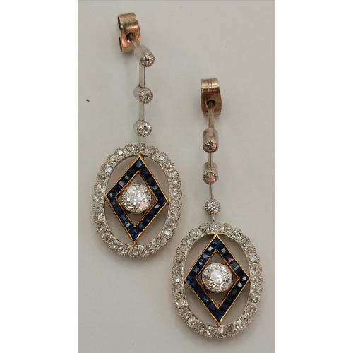 402 - A pair of Art Deco platinum and 18 carat gold diamond and sapphire pendant earrings, the oval pendan... 