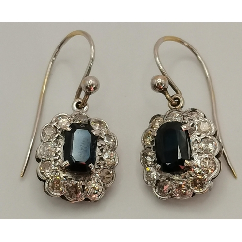 403 - A pair of diamond and sapphire cluster pendant earrings, early 20th Century, the oval pendants each ... 