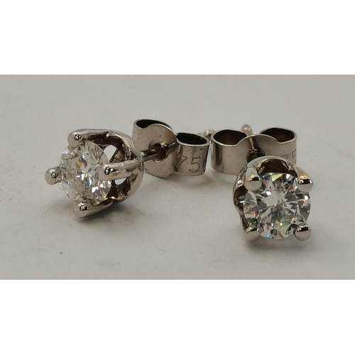 406f - A pair of 18ct gold white gold claw-set single stone diamond earrings, diamonds 0.70cts each