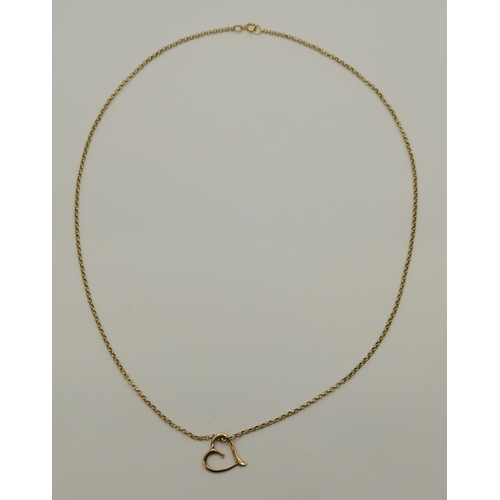 409 - A 9 carat gold necklace chain, stamped '375', with yellow metal heart pendant (unmarked). Chain 50cm... 