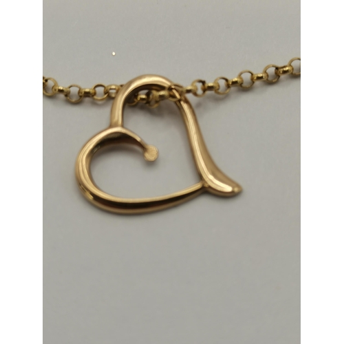 409 - A 9 carat gold necklace chain, stamped '375', with yellow metal heart pendant (unmarked). Chain 50cm... 