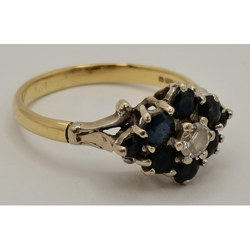 410 - An 18 carat gold blue and white stone cluster ring, the solitaire white stone enclosed by eight blue... 