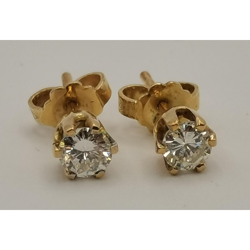 411 - Five pairs of stud earrings including a pair of 18 carat gold and white stone studs, stamped '750'; ... 