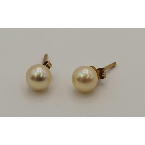 411 - Five pairs of stud earrings including a pair of 18 carat gold and white stone studs, stamped '750'; ... 