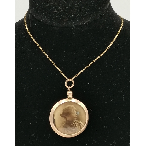 425 - A 9 carat gold open-faced double-sided locket on chain, the circular pendant hallmarked, the chain s... 