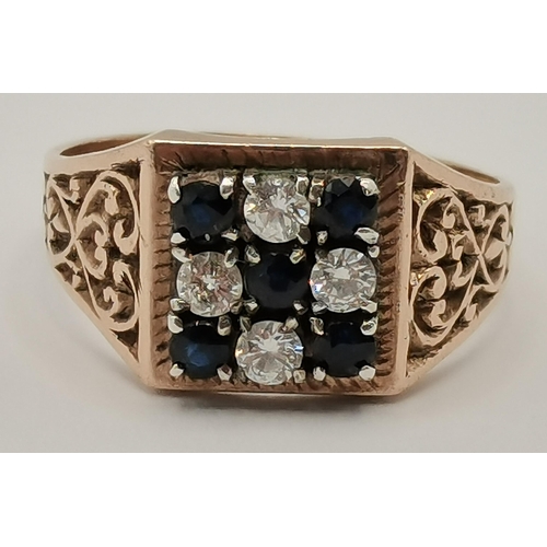 434 - A 9 carat gold cluster ring, the central blue stone surrounded by six white stones in a flowerhead f... 