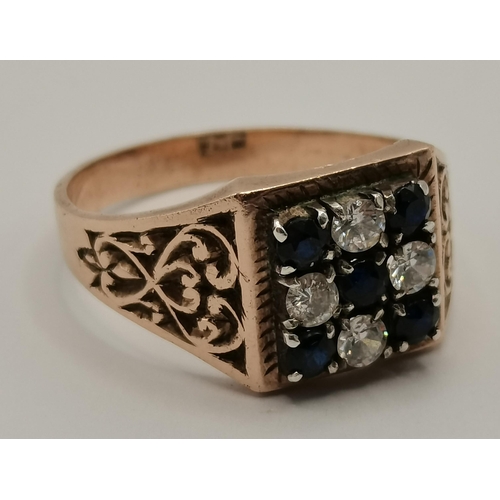 434 - A 9 carat gold cluster ring, the central blue stone surrounded by six white stones in a flowerhead f... 