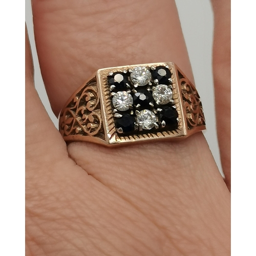 434 - A 9 carat gold cluster ring, the central blue stone surrounded by six white stones in a flowerhead f... 