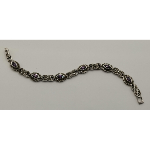 435 - A small group of silver jewellery, comprising a marcasite and amethyst bracelet, a charm bracelet, t... 