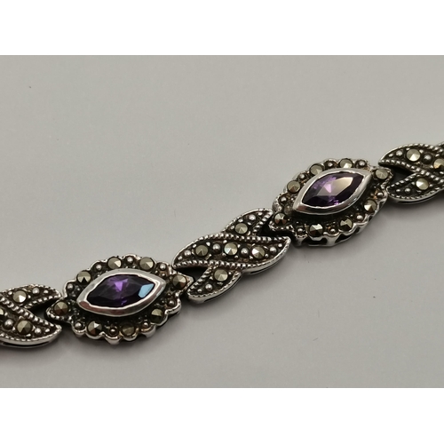 435 - A small group of silver jewellery, comprising a marcasite and amethyst bracelet, a charm bracelet, t... 