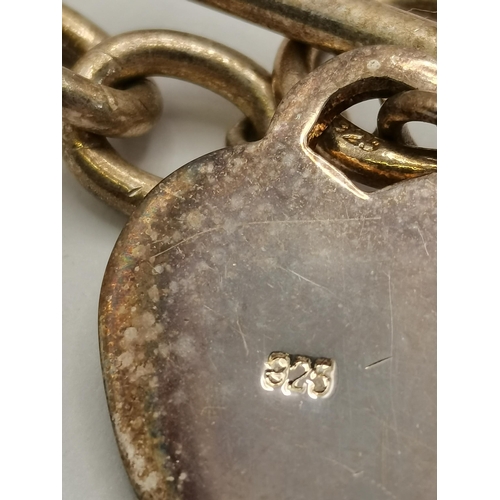 442 - A silver chain link bracelet with ring and T-bar closure, with heart charm, stamped '925'. 22cm long... 