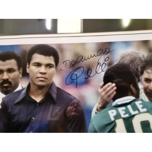 548 - A signed colour photo of MOHAMMAD ALI and PELE signed by Pele