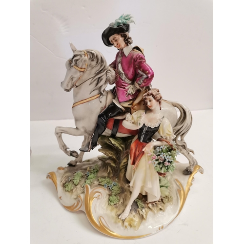 561 - A Capodemonte figure of a cavalier plus a 40cm high continental centre piece with highly decorative ... 