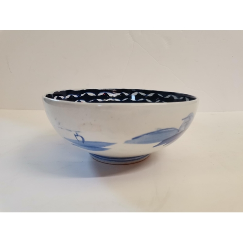 563 - An early Chinese blue and white bowl with village scene and floral decoration, 19cm