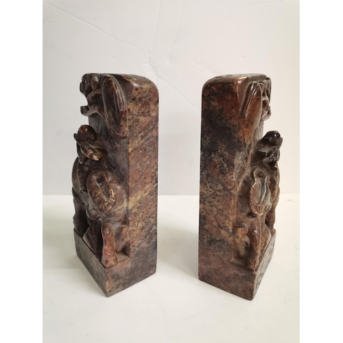 564b - A good pair of CHINESE soapstone/ granite carved stands, 19cm high .Highly decorated with an ox and ... 