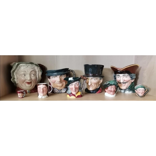 595 - A collection of Royal Doulton character / toby jugs plus others .