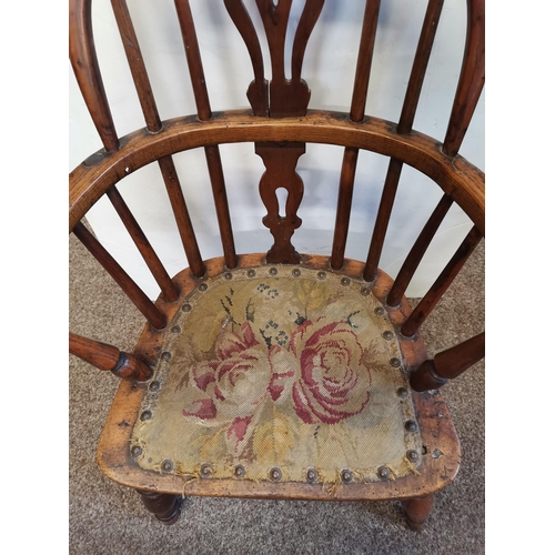 602 - A child's yewood Windsor chair with applied tapestry seat. Height of back 65cm