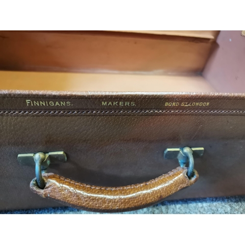 603 - An antique tan leather suitcase, by Finnigans of Bond Street, leather lined, gilt-stamped 'FINNIGANS... 