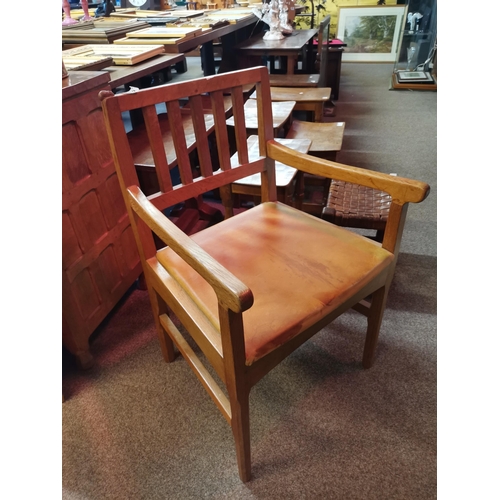 610 - Robert Thompson, a Mouseman oak armchair with leather pad seat, on faceted forelegs, with carved mou... 