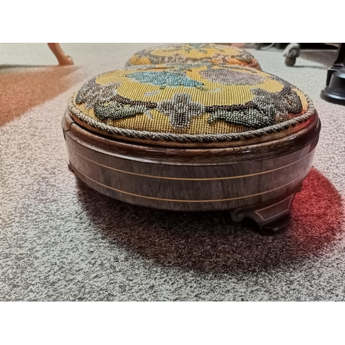 618 - A pair of antique embroidered and beaded inlaid mahogany footstools, with floral beaded decoration t... 