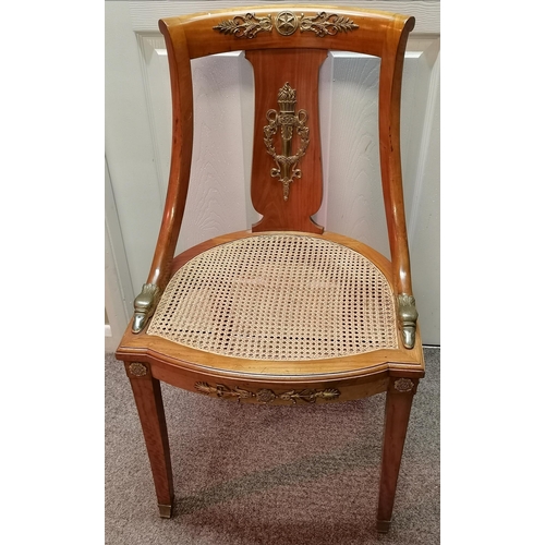 630 - A fine pair of fruitwood hall chairs with canework seats, variously applied with ornate brass decora... 