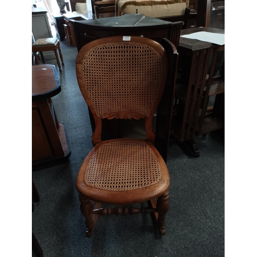 853 - A bow fronted Georgian oak corner cupboard  and Bergere rocking chair