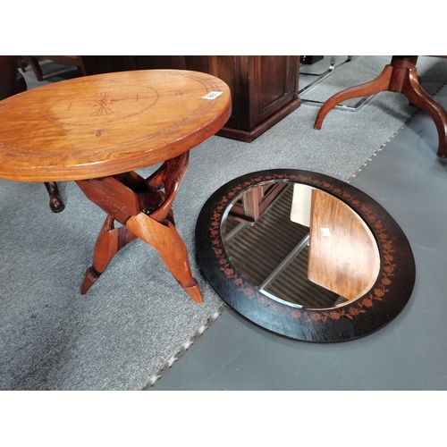 861 - An African style travelling side table plus an Arts and crafts style oval wall mirror