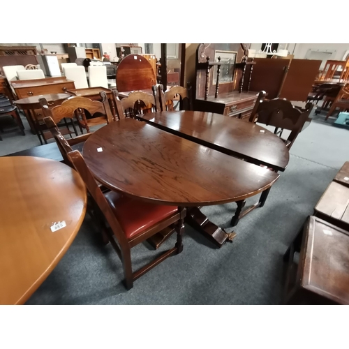 884 - An oak carved extending dining table and 5 x chairs