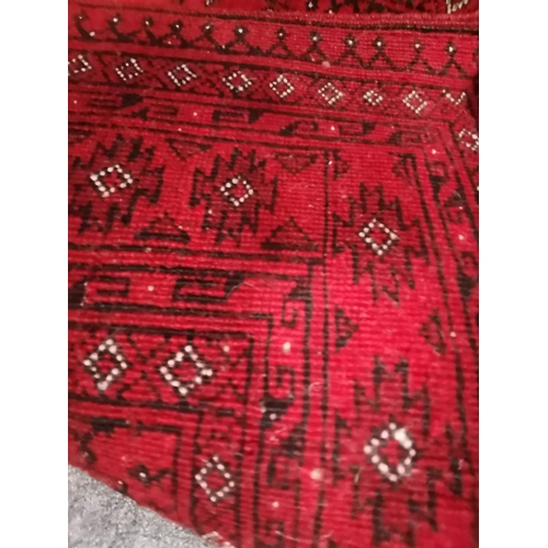 902 - A small Afghan rug, the red ground with two columns of black and white guls, the main border enclose... 