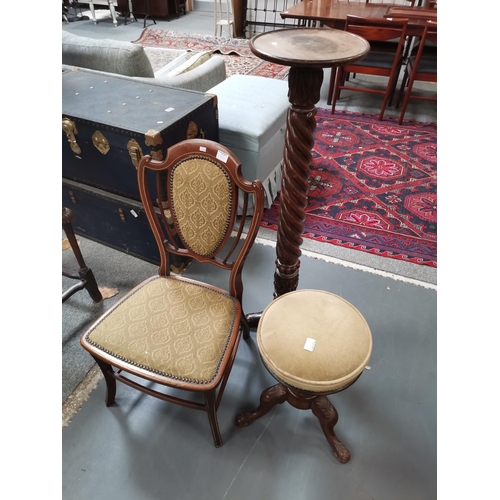 912a - A Victorian nursing chair, a Victorian carved plant stand and a Victorian revolving piano stool