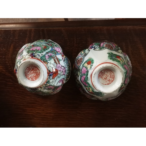 134 - A pair of 29cm high Famille Rose style vases, plus a pair of small dishes to match