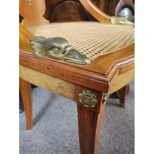 630 - A fine pair of fruitwood hall chairs with canework seats, variously applied with ornate brass decora... 