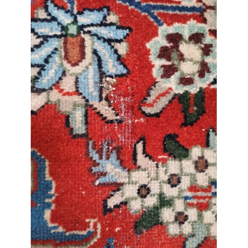 901 - A large Afghan carpet, the beige field with a mauve medallion and all-over multicoloured scrolling f... 