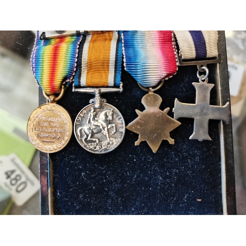 464 - A First World War Military Cross and set of miniatures comprising MC, a 1914 Star with 5th Aug-22nd ... 