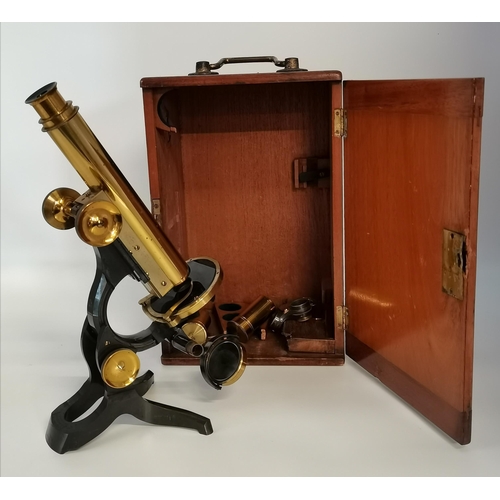 132 - A brass scientific microscope, late 19th Century, by Swift & Sons, London, engraved maker's mark, ad... 