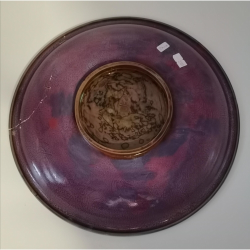 188 - A Chinese celadon and purple glaze large dish, the front in celadon green, the underside mottled pur... 