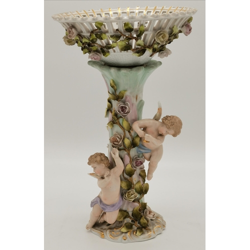 190 - Two ceramic centrepieces, likely German, each adorned with putti and flowers, one with a basket to t... 