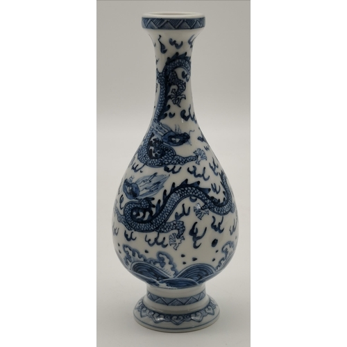 202 - A Chinese porcelain blue and white cylindrical sleeve vase, decorated with figures in a garden, four... 