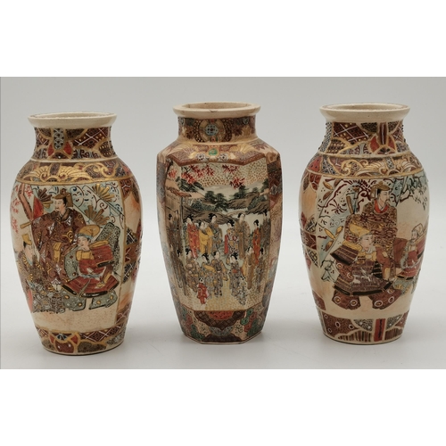 210 - Three Japanese Satsuma vases, comprising a hexagonal vase decorated with a large group of figures in... 