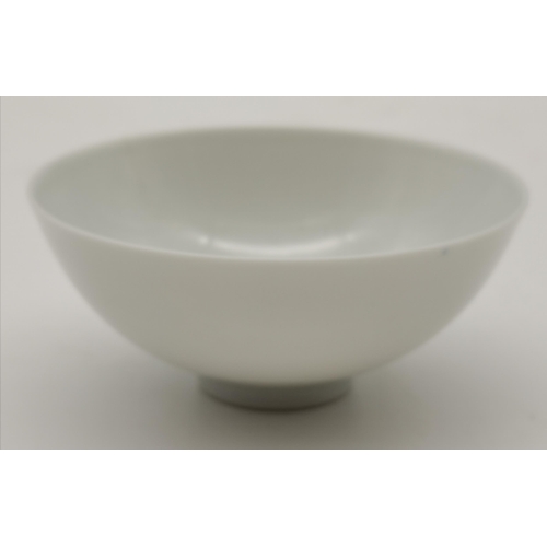 213 - A Chinese porcelain white glazed bowl, 18th Century, with six character mark to base, (a/f). 9.2cm d... 