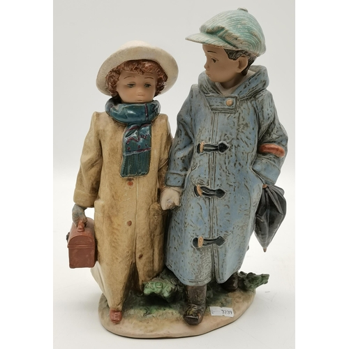 218 - A Lladro porcelain figure group, a boy and girl in hats and coats, holding hands, impressed marks an... 