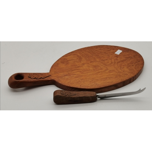 230 - An Oakleafman oak cheese board and cheese knife, the board lightly adzed, carved oak leaf signature ... 