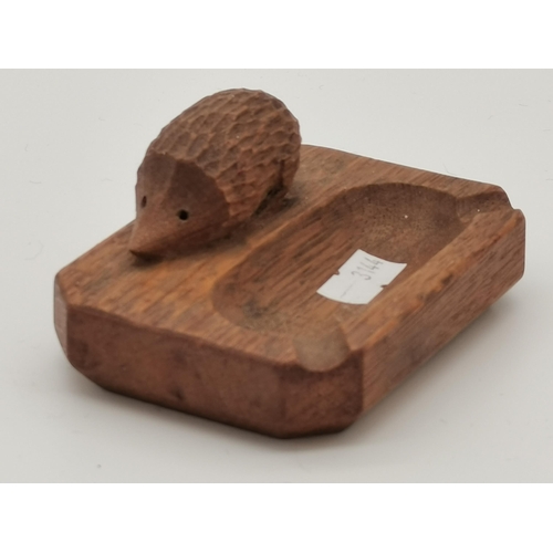 237 - Nick Hill, a Hedgehogman oak ash tray, rectangular with canted corners, lightly adzed, with carved h... 