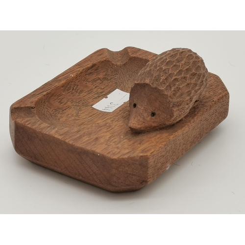 238 - Nick Hill, a Hedgehogman oak ash tray, rectangular with canted corners, lightly adzed, with carved h... 