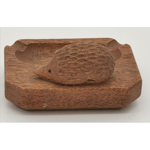 238 - Nick Hill, a Hedgehogman oak ash tray, rectangular with canted corners, lightly adzed, with carved h... 