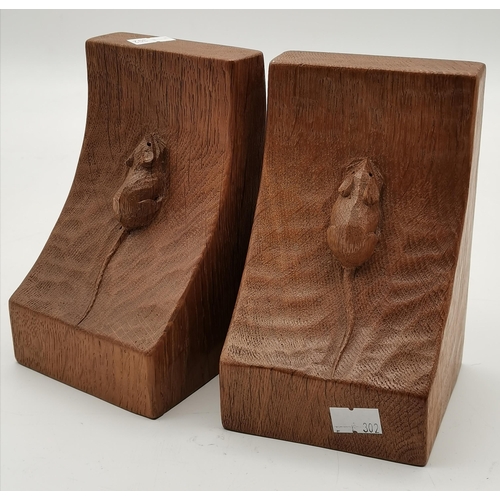 243 - Robert Thompson, a pair of Mouseman oak bookends, of typical form, each with carved mouse signature.... 