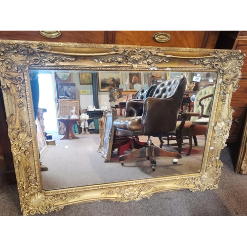 247 - An antique large gilt framed overmantel mirror, rectangular, with scrolling foliate decoration. 88.5... 