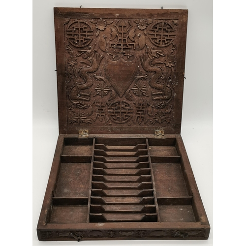 58 - A Chinese carved wooden box, square, the hinged cover with a carved four-toed dragon to the centre w... 