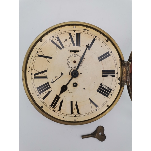 257 - An Antique brass Ships clock with key